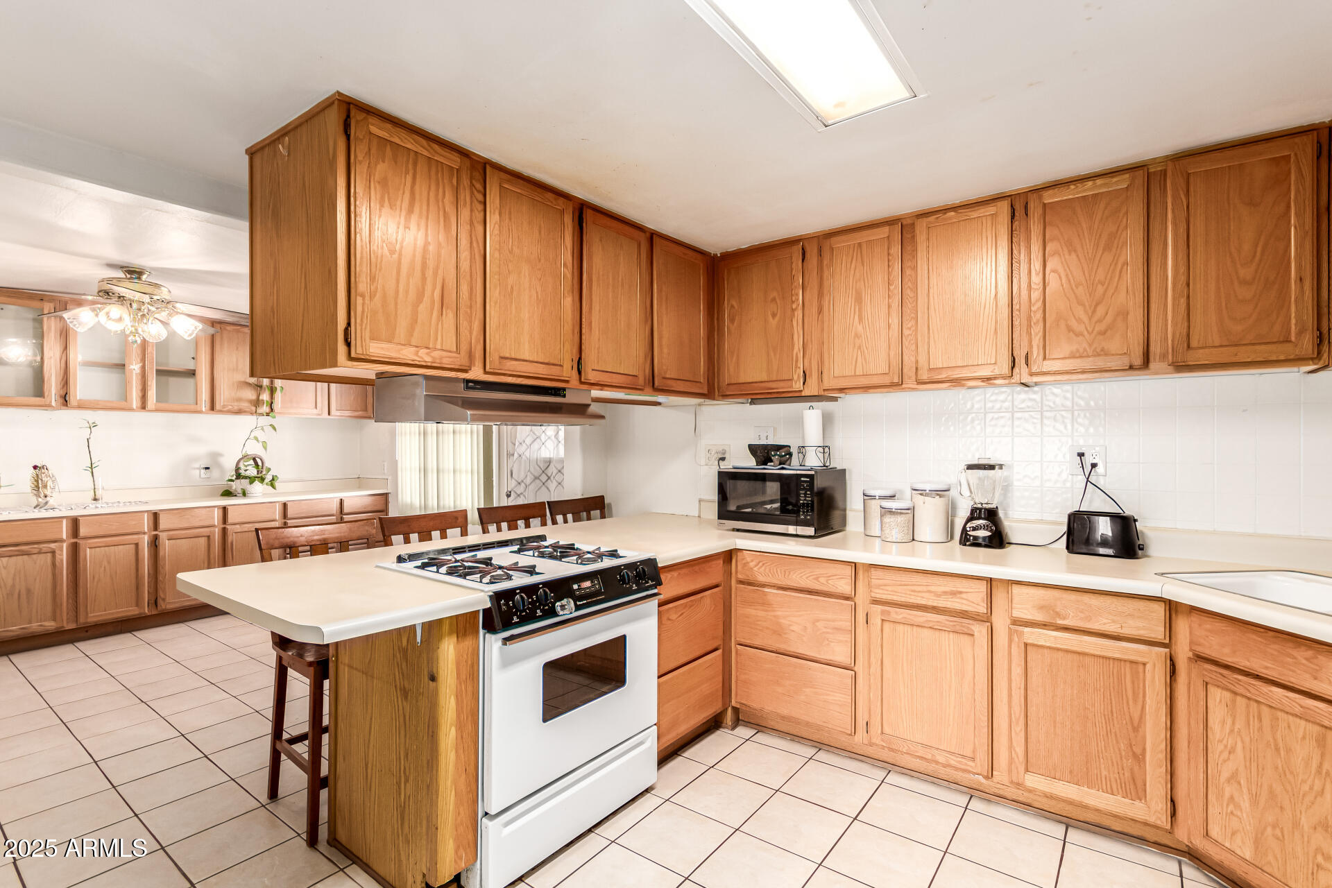 710 East Atlanta Avenue Phoenix, AZ 85040 - Photo 7 of 21 a kitchen with granite countertop a stove sink and cabinets