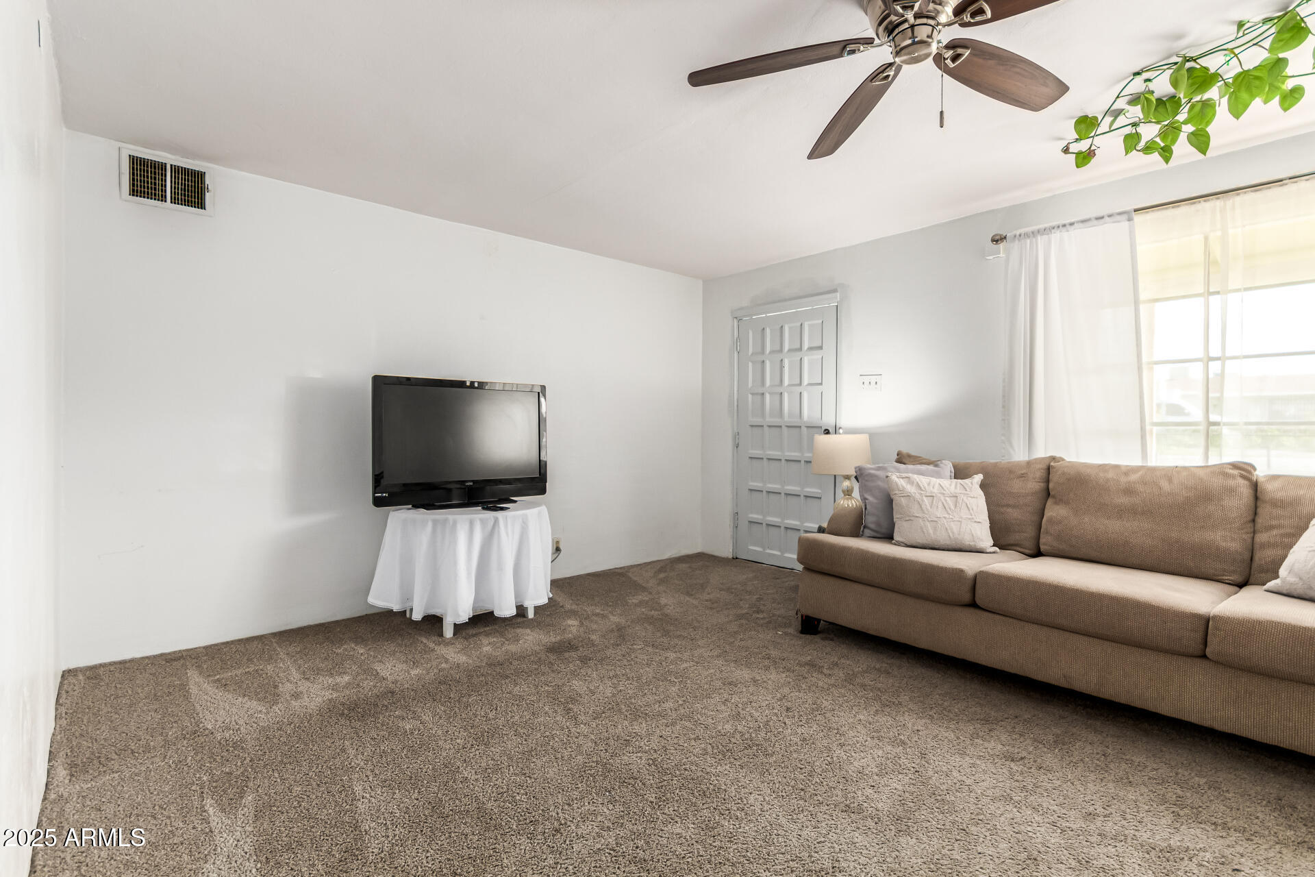710 East Atlanta Avenue Phoenix, AZ 85040 - Photo 10 of 21 a living room with furniture and a flat screen tv