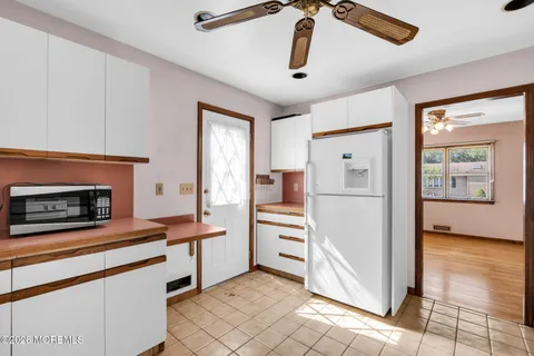 a kitchen with stainless steel appliances kitchen island granite countertop a refrigerator and a stove