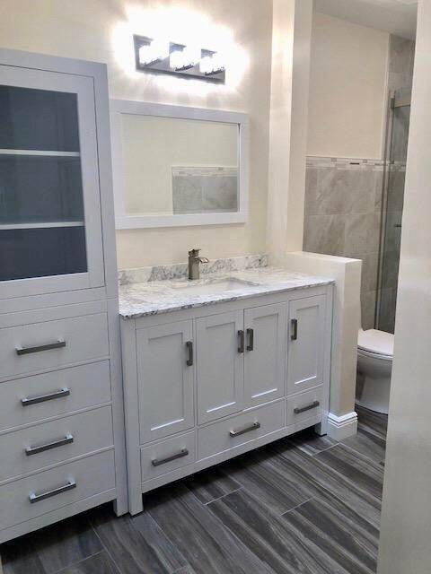 a bathroom with a sink a vanity and a mirror