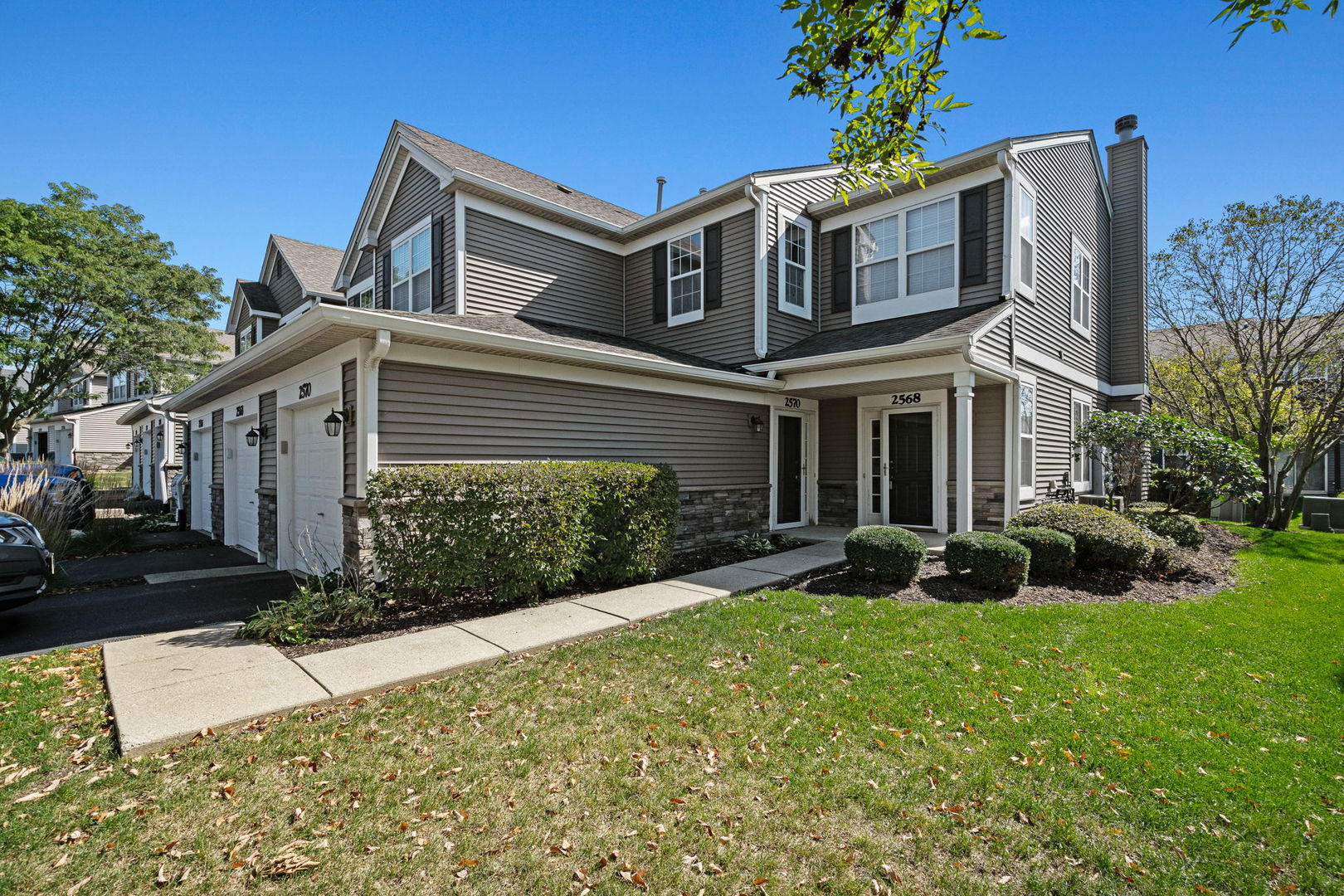 2568 Golf Ridge Circle, Unit 2568 Naperville, IL 60563 - Photo 1 of 18 a front view of a house with garden and porch