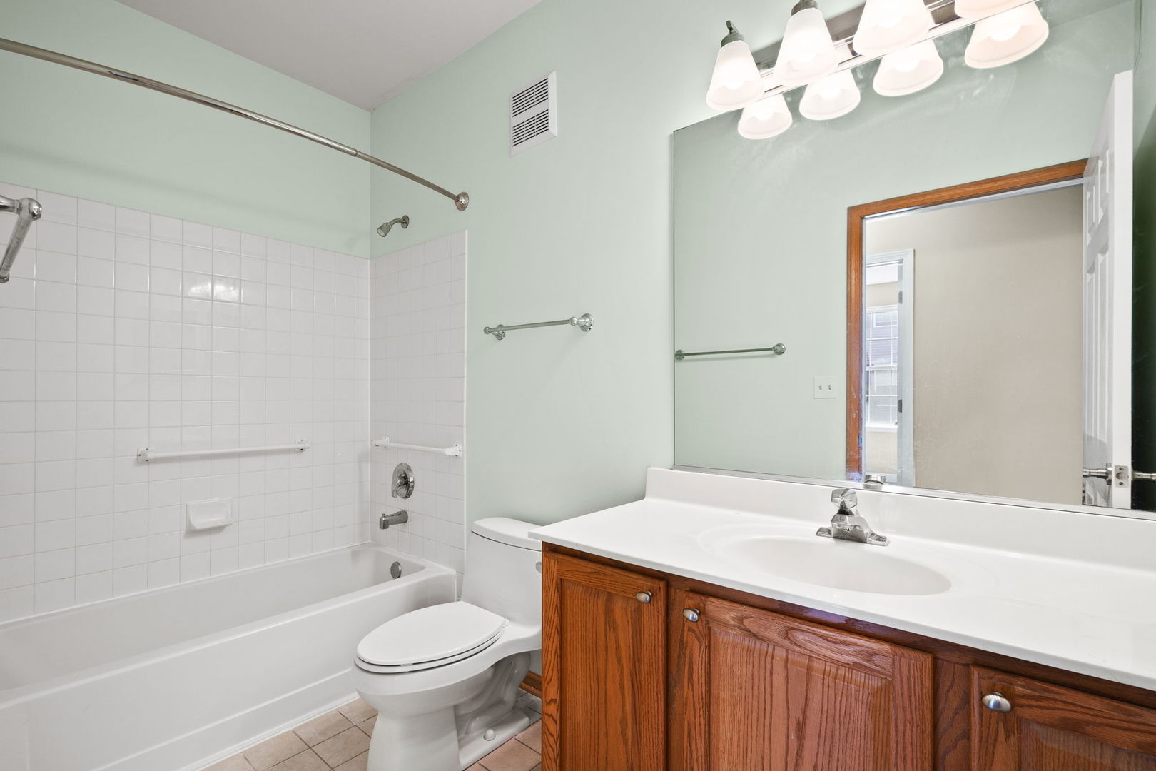 2568 Golf Ridge Circle, Unit 2568 Naperville, IL 60563 - Photo 14 of 18 a bathroom with a granite countertop sink a toilet a mirror and shower