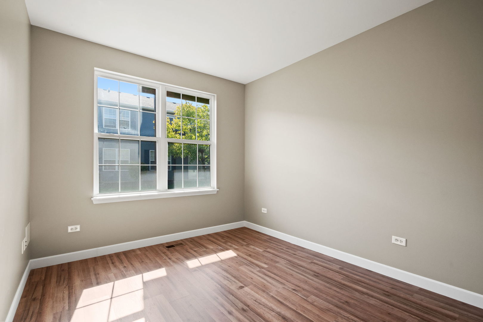 2568 Golf Ridge Circle, Unit 2568 Naperville, IL 60563 - Photo 15 of 18 a view of an empty room with wooden floor and a window