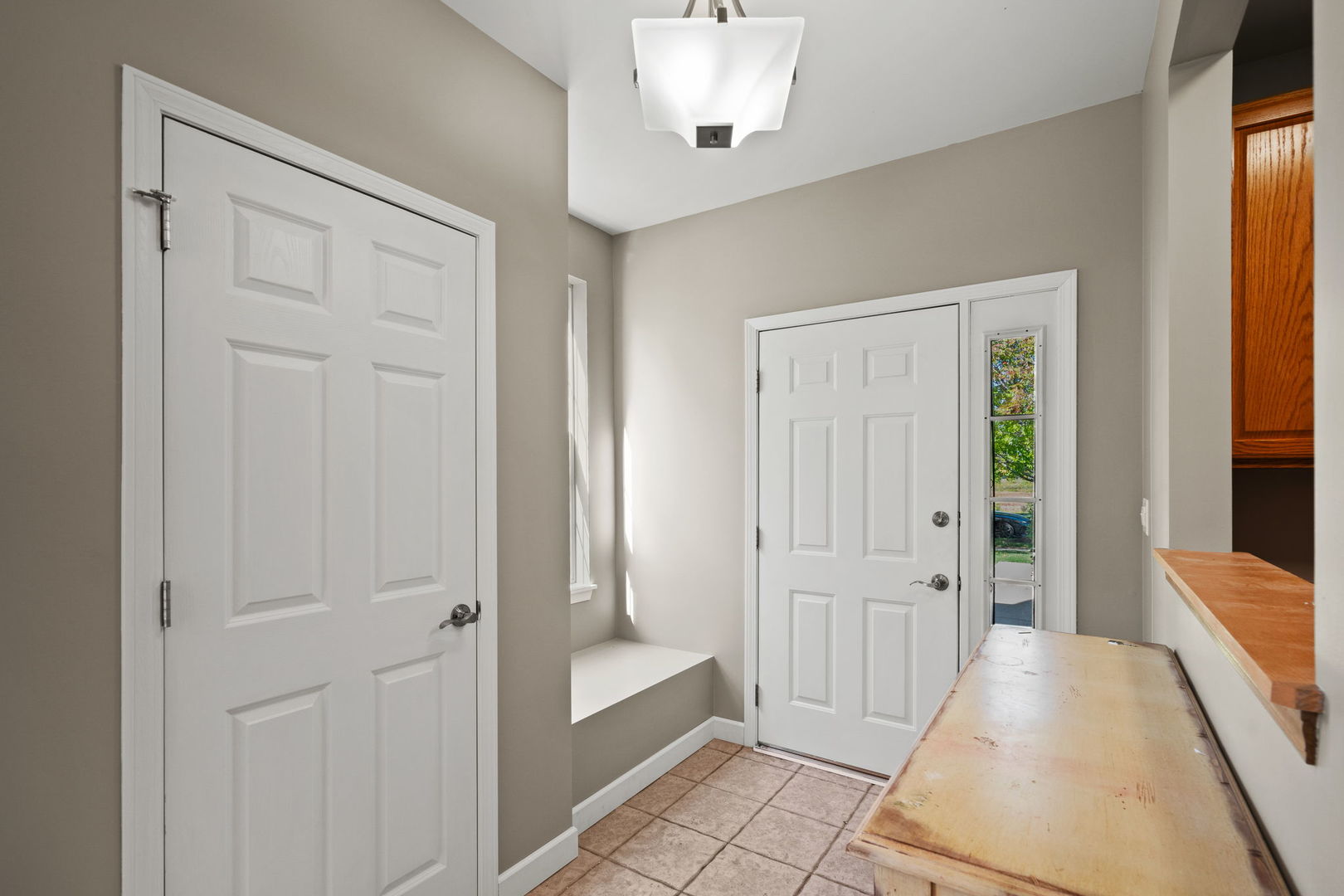 2568 Golf Ridge Circle, Unit 2568 Naperville, IL 60563 - Photo 2 of 18 a view of a hallway with wooden floor and cabinet area