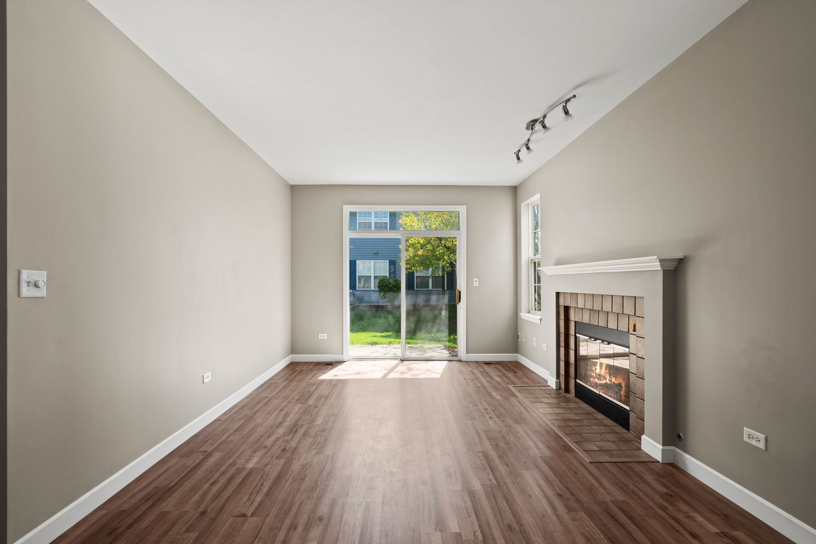 2568 Golf Ridge Circle, Unit 2568 Naperville, IL 60563 - Photo 6 of 18 a view of an empty room with a window and wooden floor