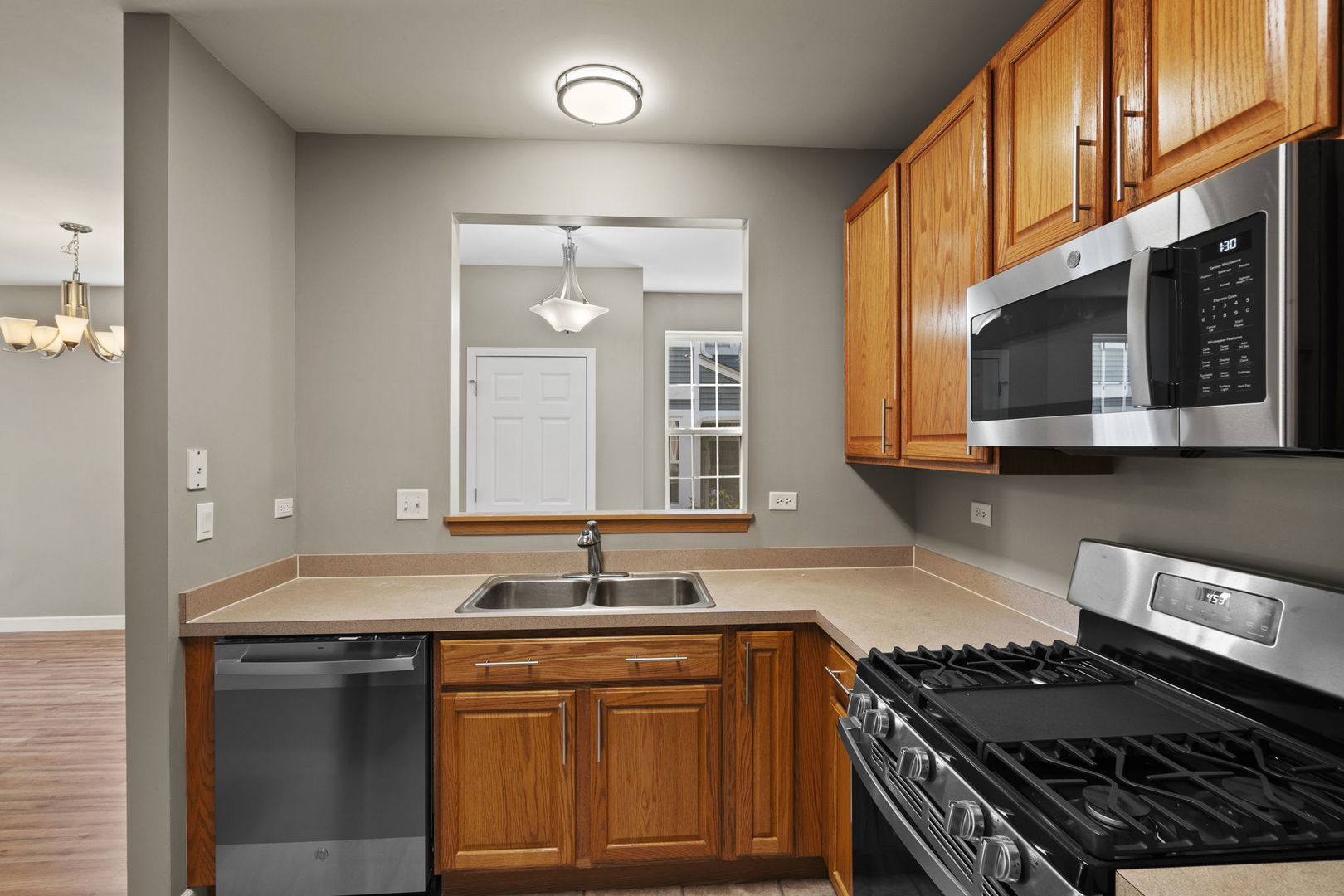 2568 Golf Ridge Circle, Unit 2568 Naperville, IL 60563 - Photo 8 of 18 a kitchen with stainless steel appliances granite countertop a stove and a sink