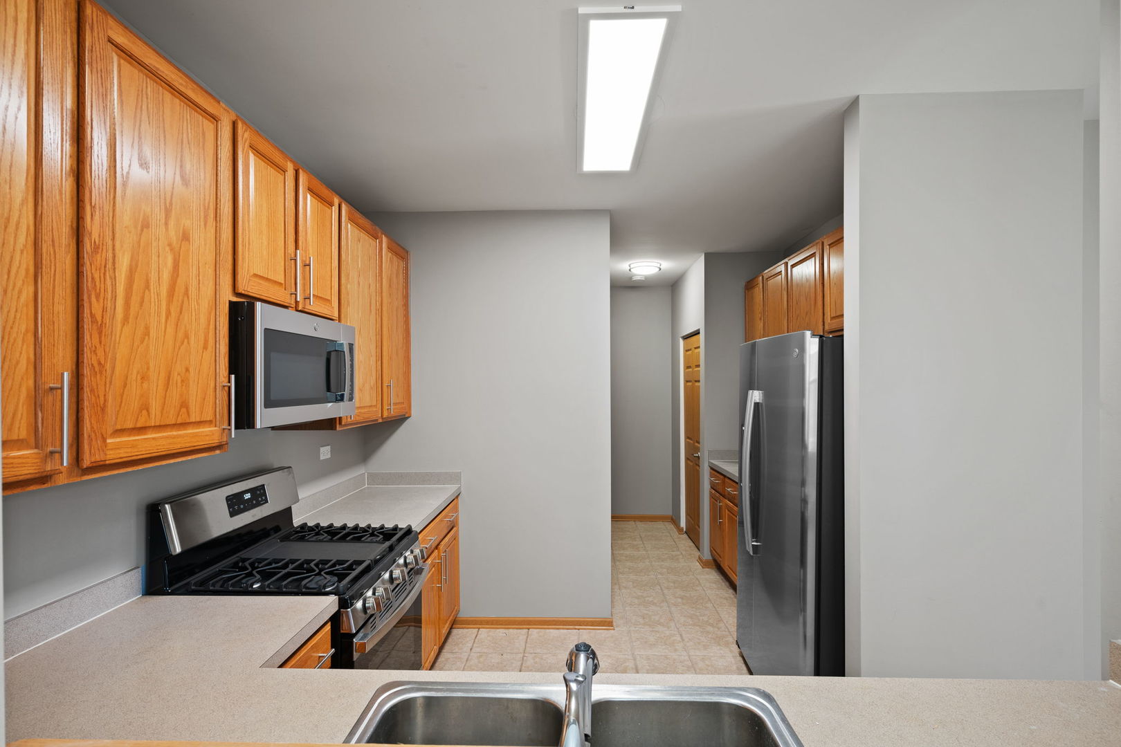 2568 Golf Ridge Circle, Unit 2568 Naperville, IL 60563 - Photo 9 of 18 a kitchen with stainless steel appliances granite countertop a refrigerator and a sink