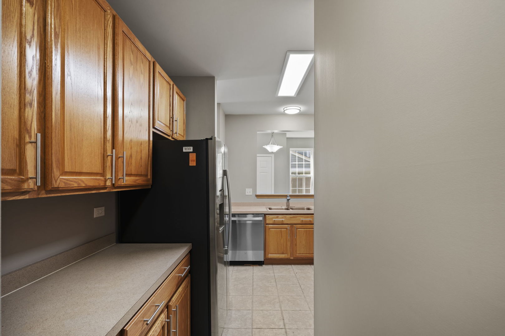 2568 Golf Ridge Circle, Unit 2568 Naperville, IL 60563 - Photo 10 of 18 a kitchen with cabinets and a refrigerator