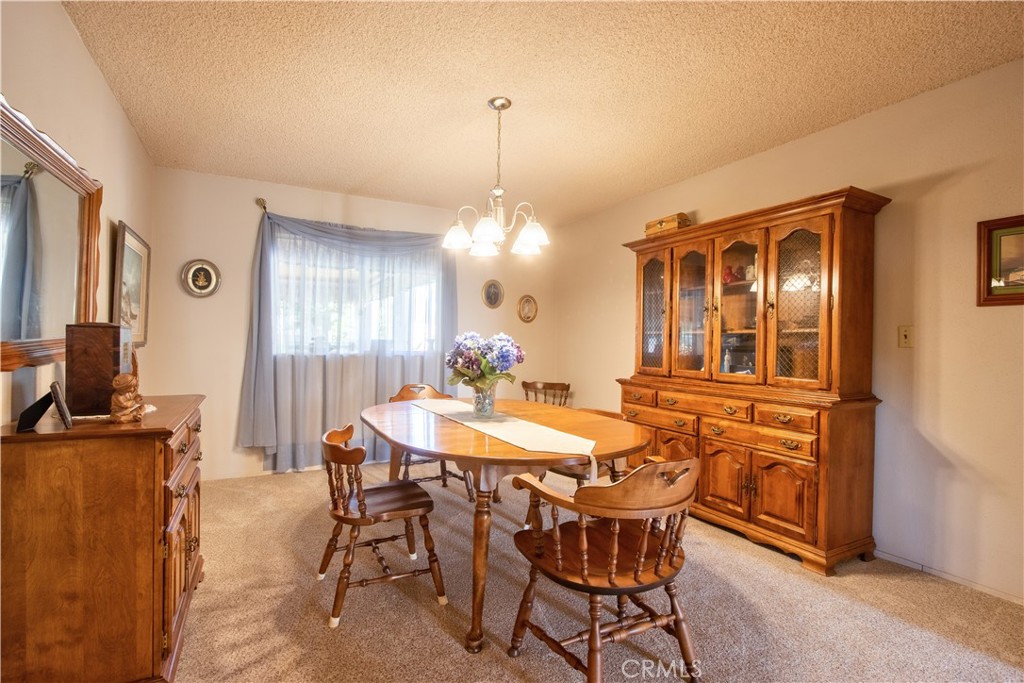 335 Zada Lane Vista, CA 92084 - Photo 17 of 44 a dining room with furniture a chandelier and window