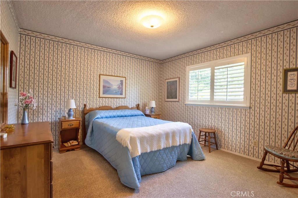 335 Zada Lane Vista, CA 92084 - Photo 20 of 44 a bedroom with a bed chair and a window