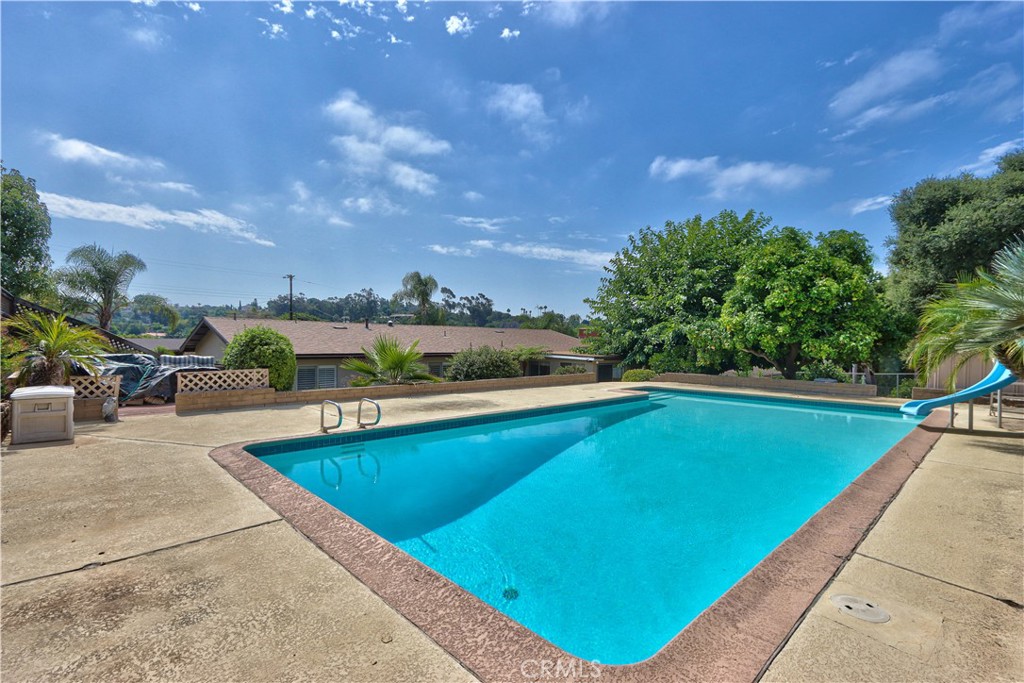 335 Zada Lane Vista, CA 92084 - Photo 2 of 44 a view of swimming pool with seating area and trees in the background