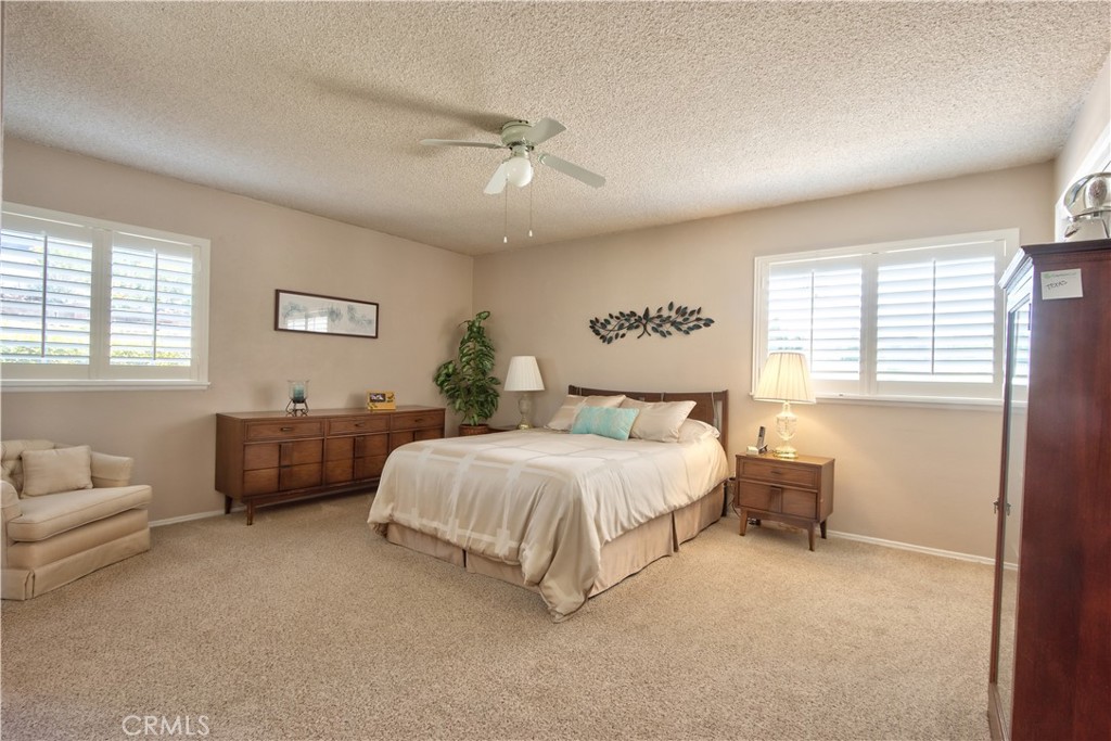 335 Zada Lane Vista, CA 92084 - Photo 26 of 44 a spacious bedroom with a bed and a couch