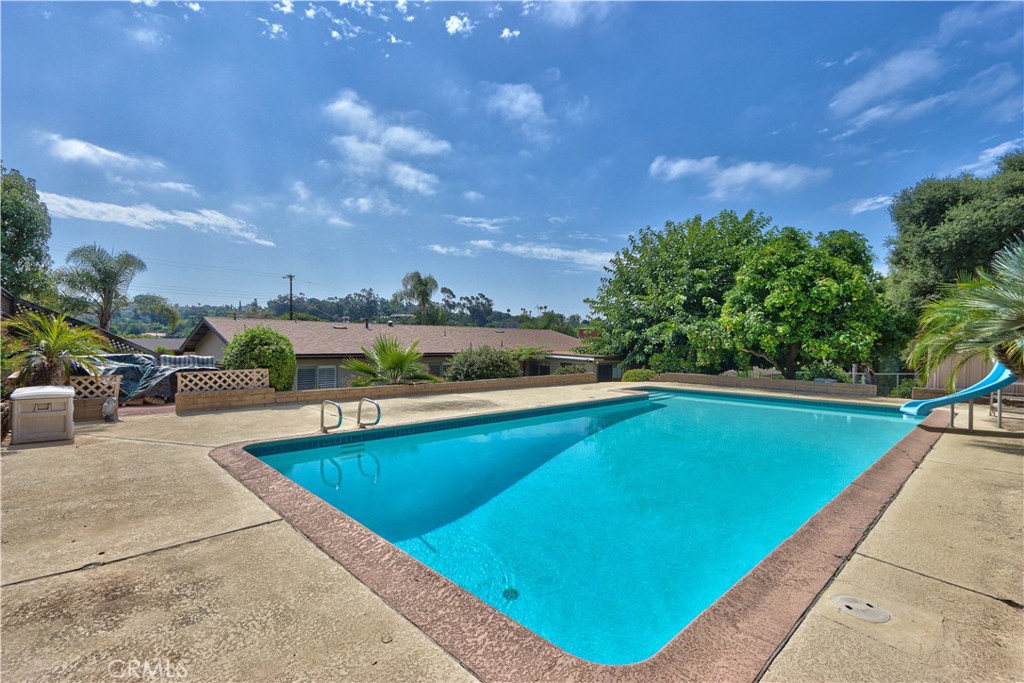 335 Zada Lane Vista, CA 92084 - Photo 32 of 44 a view of swimming pool with seating area and trees in the background