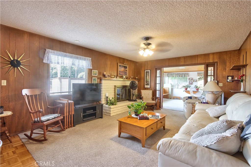335 Zada Lane Vista, CA 92084 - Photo 8 of 44 a living room with furniture a fireplace and a flat screen tv