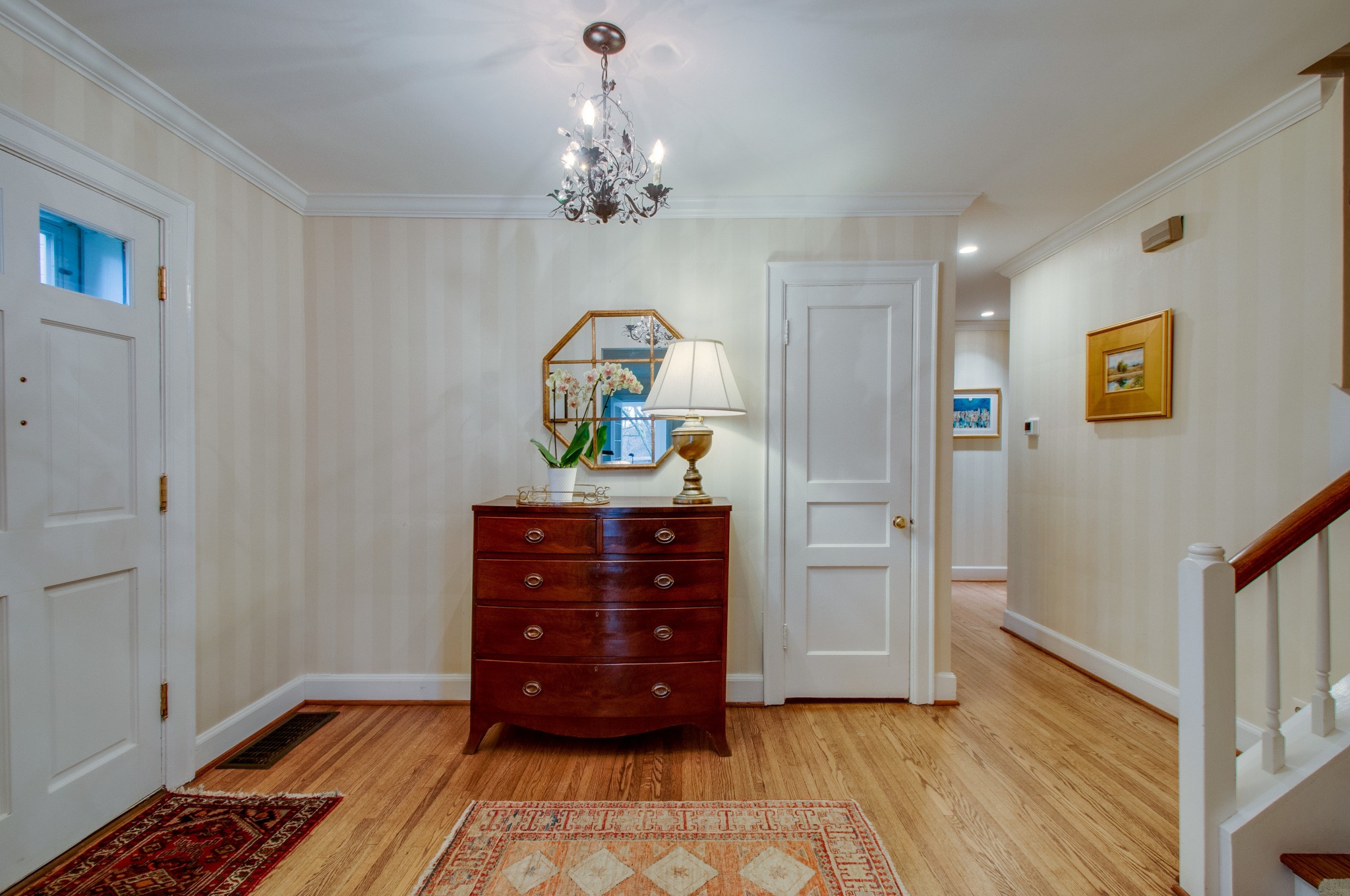 144 Cheek Road Nashville, TN 37205 - Photo 2 of 15 a room with a dresser and a chandelier