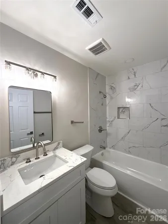 a bathroom with a sink toilet tub and shower