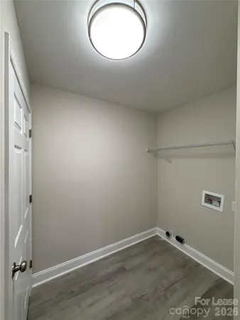a view of a room with wooden floor and a window