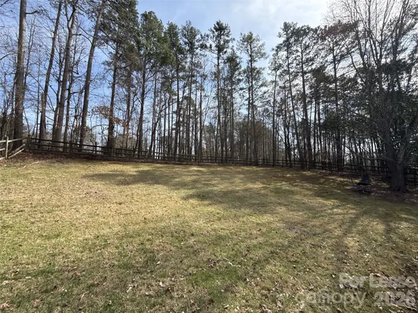 a view of a yard with a house in the background