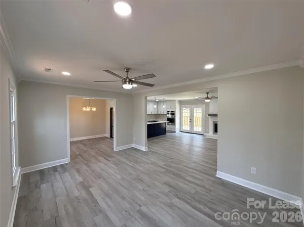 a view of empty room with wooden floor
