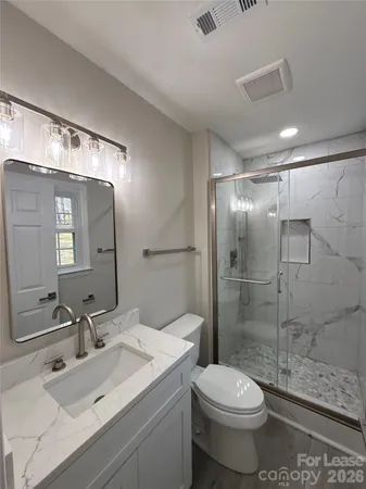 a bathroom with a sink toilet and shower
