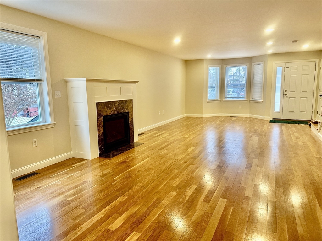 183 Summer Street, Unit 183 Watertown, MA 02472 - Photo 1 of 12 a view of an empty room with wooden floor
