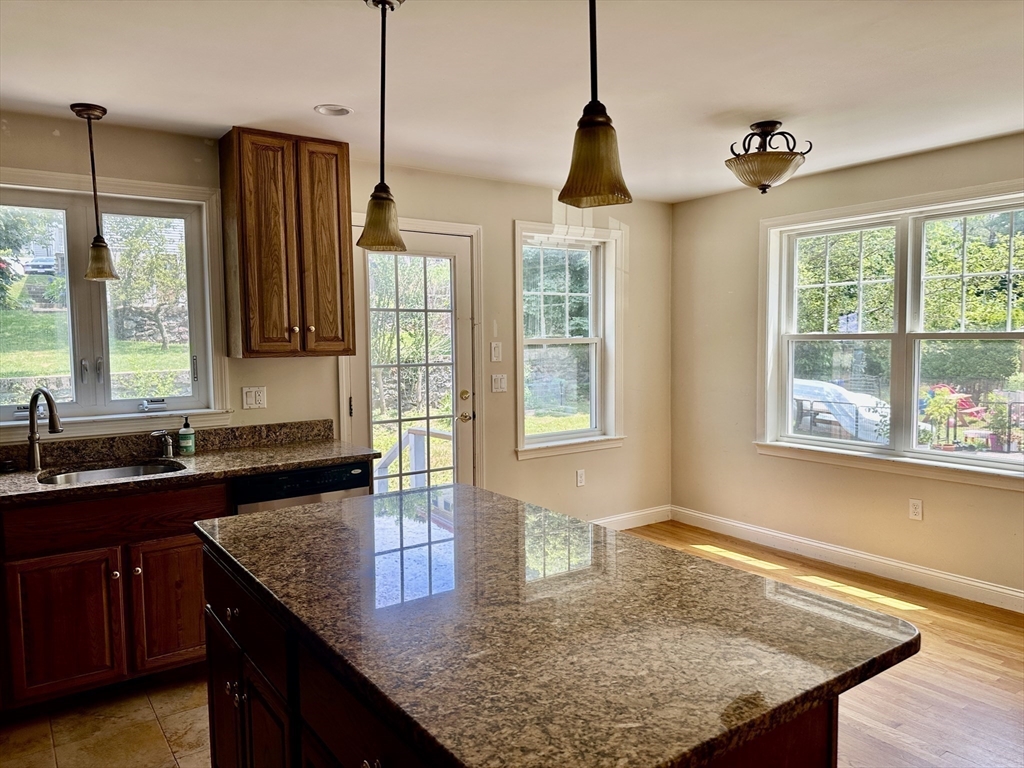 183 Summer Street, Unit 183 Watertown, MA 02472 - Photo 4 of 12 a kitchen with sink refrigerator and window