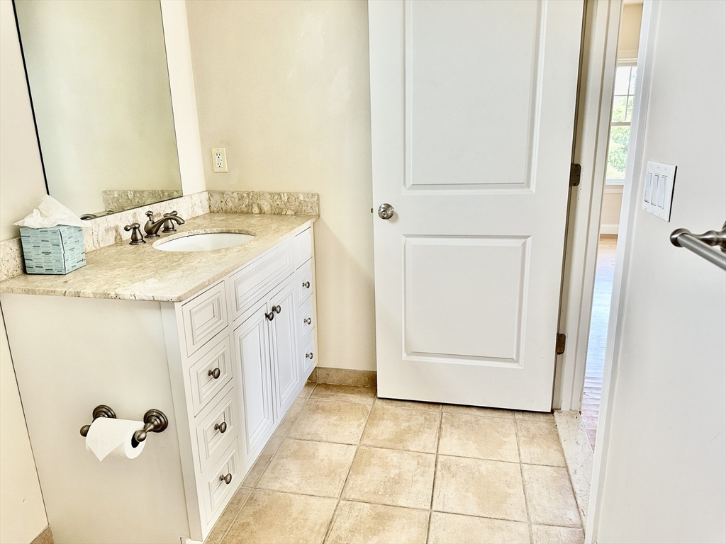 183 Summer Street, Unit 183 Watertown, MA 02472 - Photo 10 of 12 a bathroom with a sink and mirror