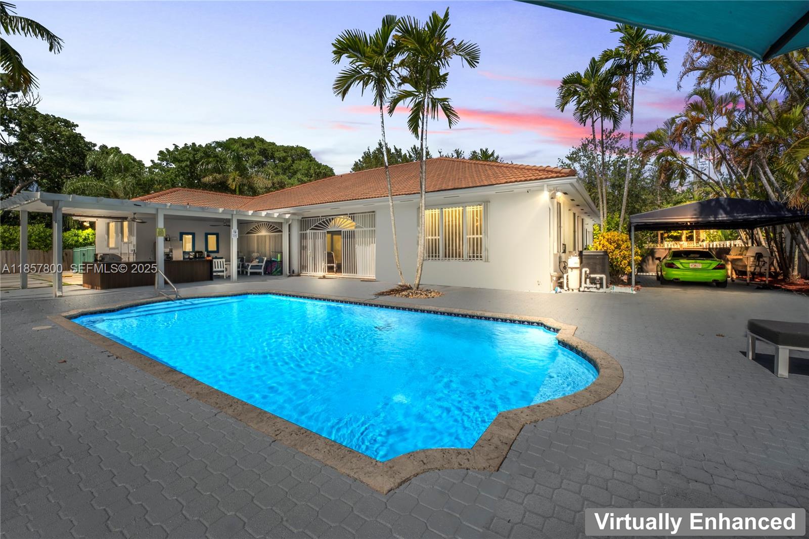 5750 Southwest 67th Avenue Miami, FL 33143 - Photo 11 of 62 a view of a house with a swimming pool and a yard