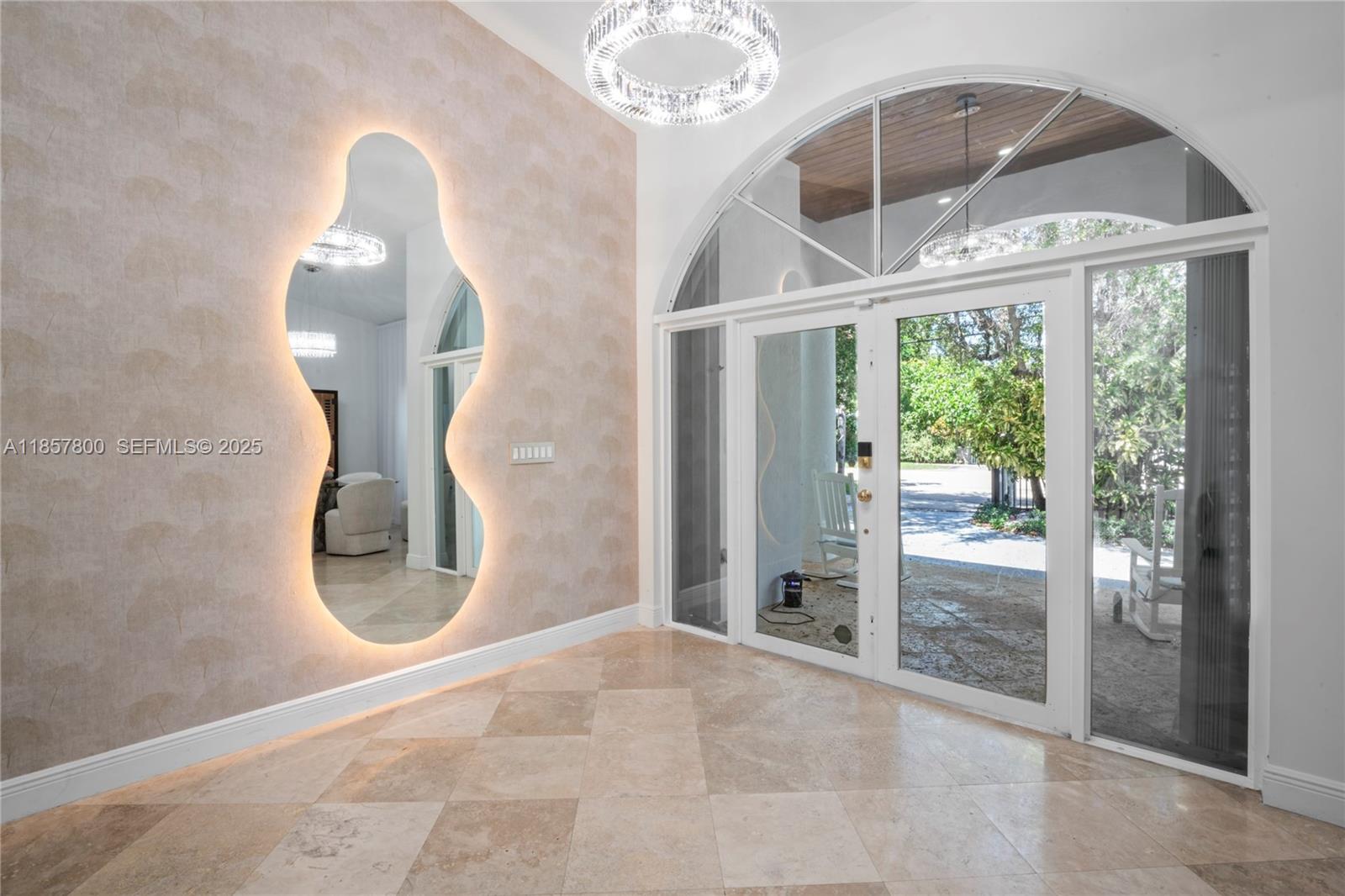 5750 Southwest 67th Avenue Miami, FL 33143 - Photo 14 of 62 a view of a livingroom with a floor to ceiling window and an entryway