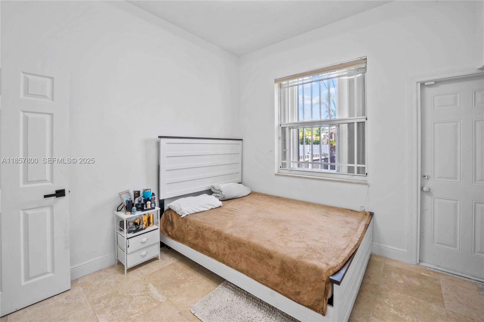 5750 Southwest 67th Avenue Miami, FL 33143 - Photo 21 of 62 a bedroom with a bed and window