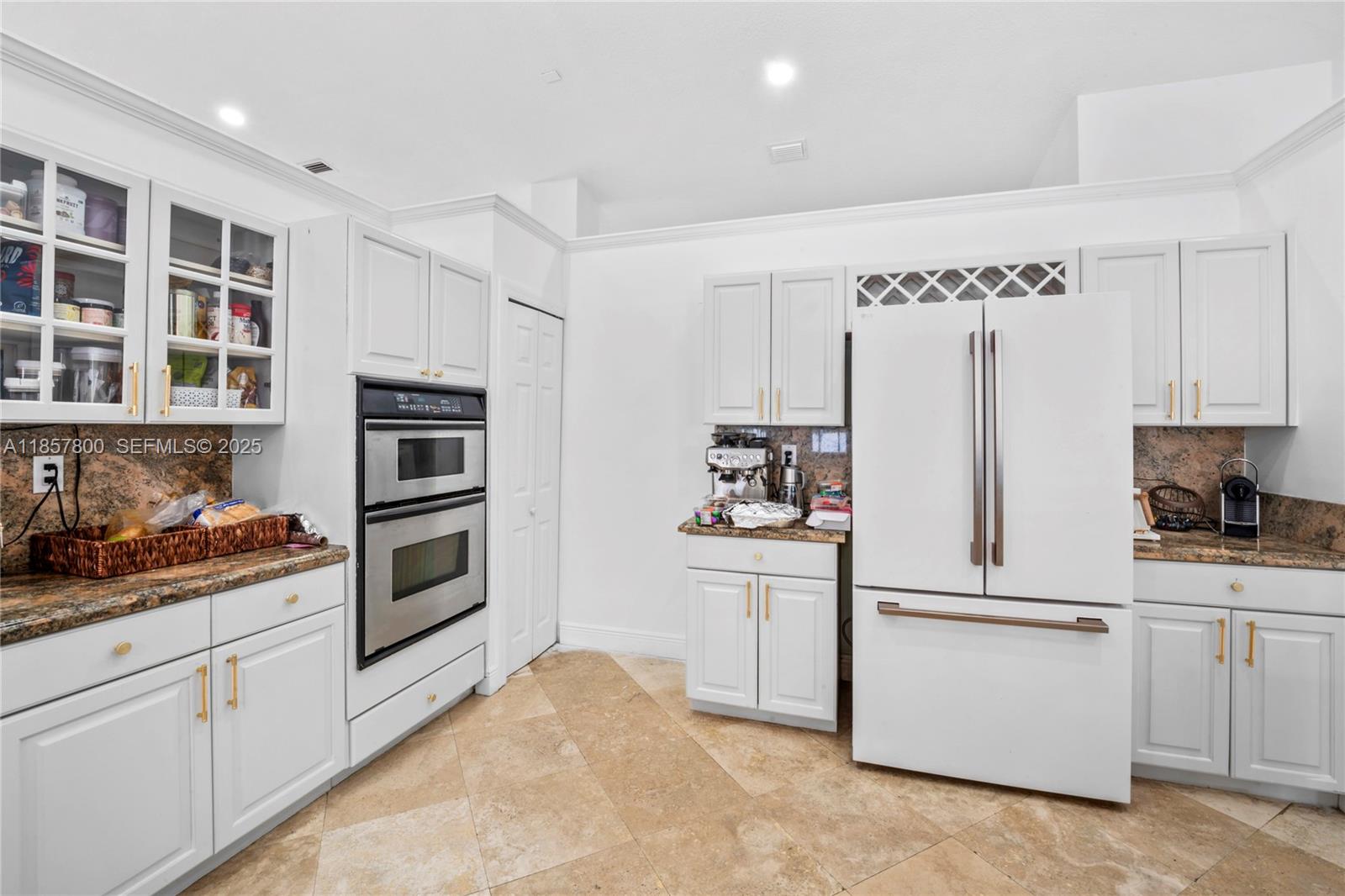 5750 Southwest 67th Avenue Miami, FL 33143 - Photo 23 of 62 a kitchen with cabinets and white appliances