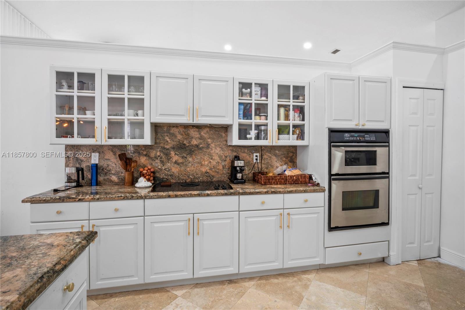 5750 Southwest 67th Avenue Miami, FL 33143 - Photo 24 of 62 a kitchen with stainless steel appliances granite countertop a stove and cabinets