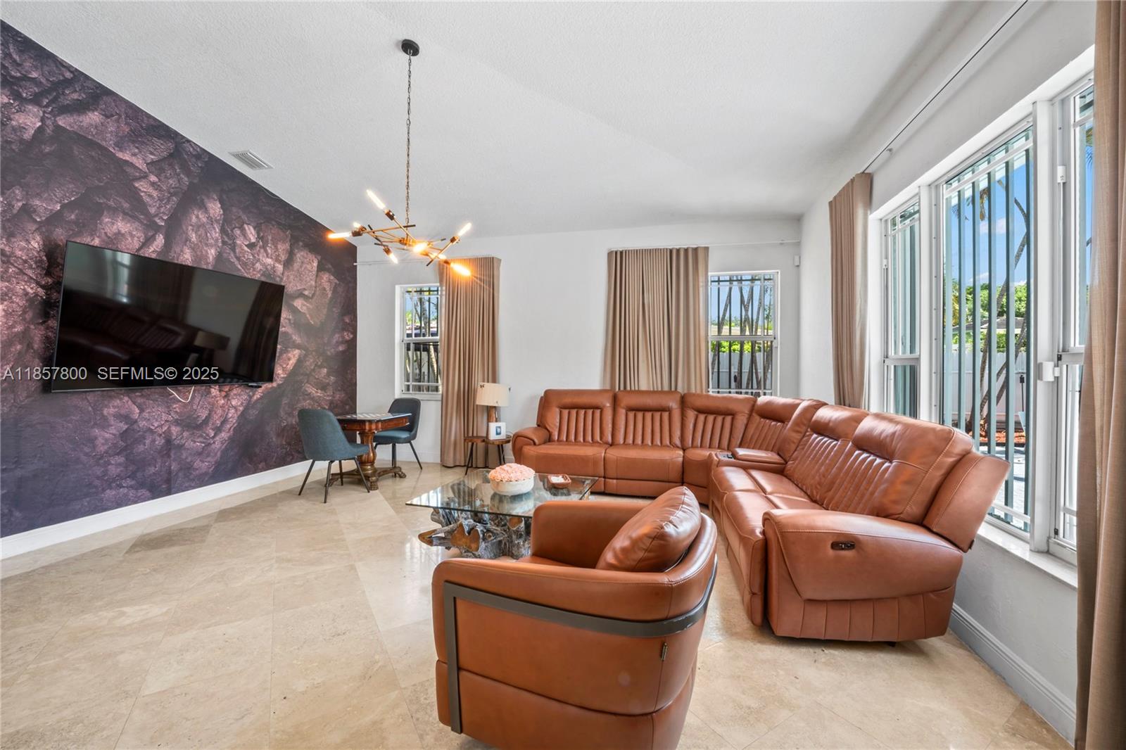 5750 Southwest 67th Avenue Miami, FL 33143 - Photo 29 of 62 a living room with furniture and a flat screen tv