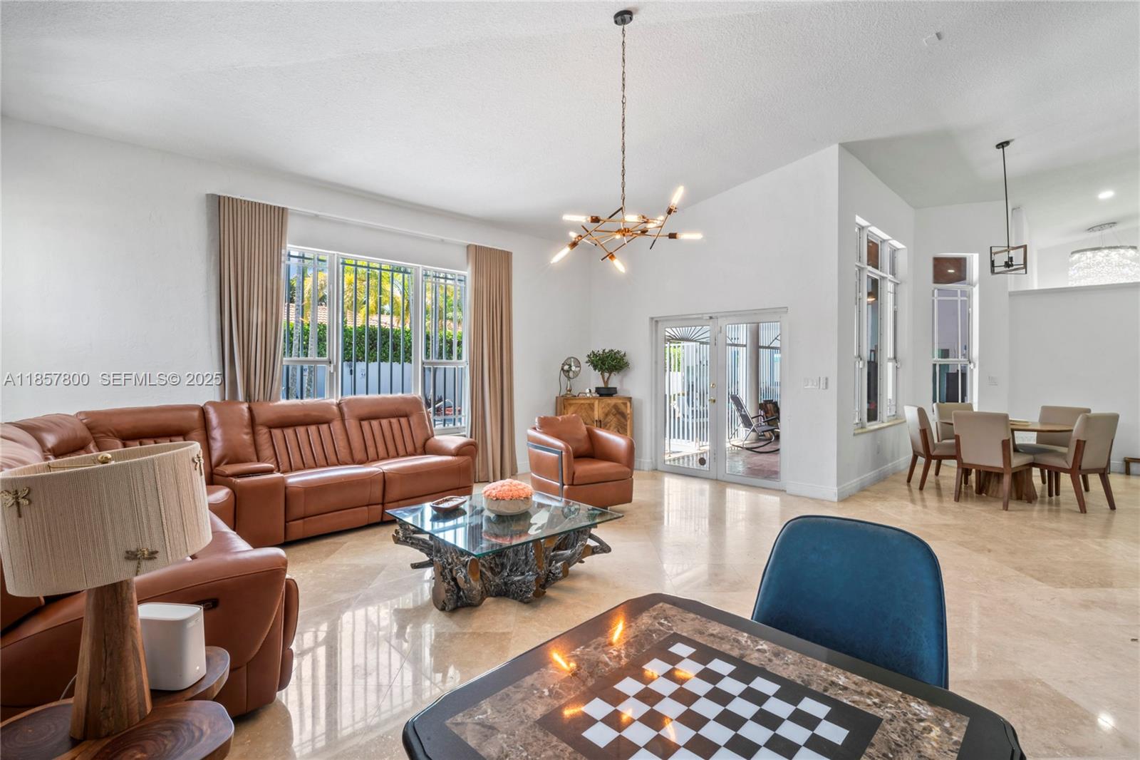 5750 Southwest 67th Avenue Miami, FL 33143 - Photo 30 of 62 a living room with furniture a lamp and a chandelier
