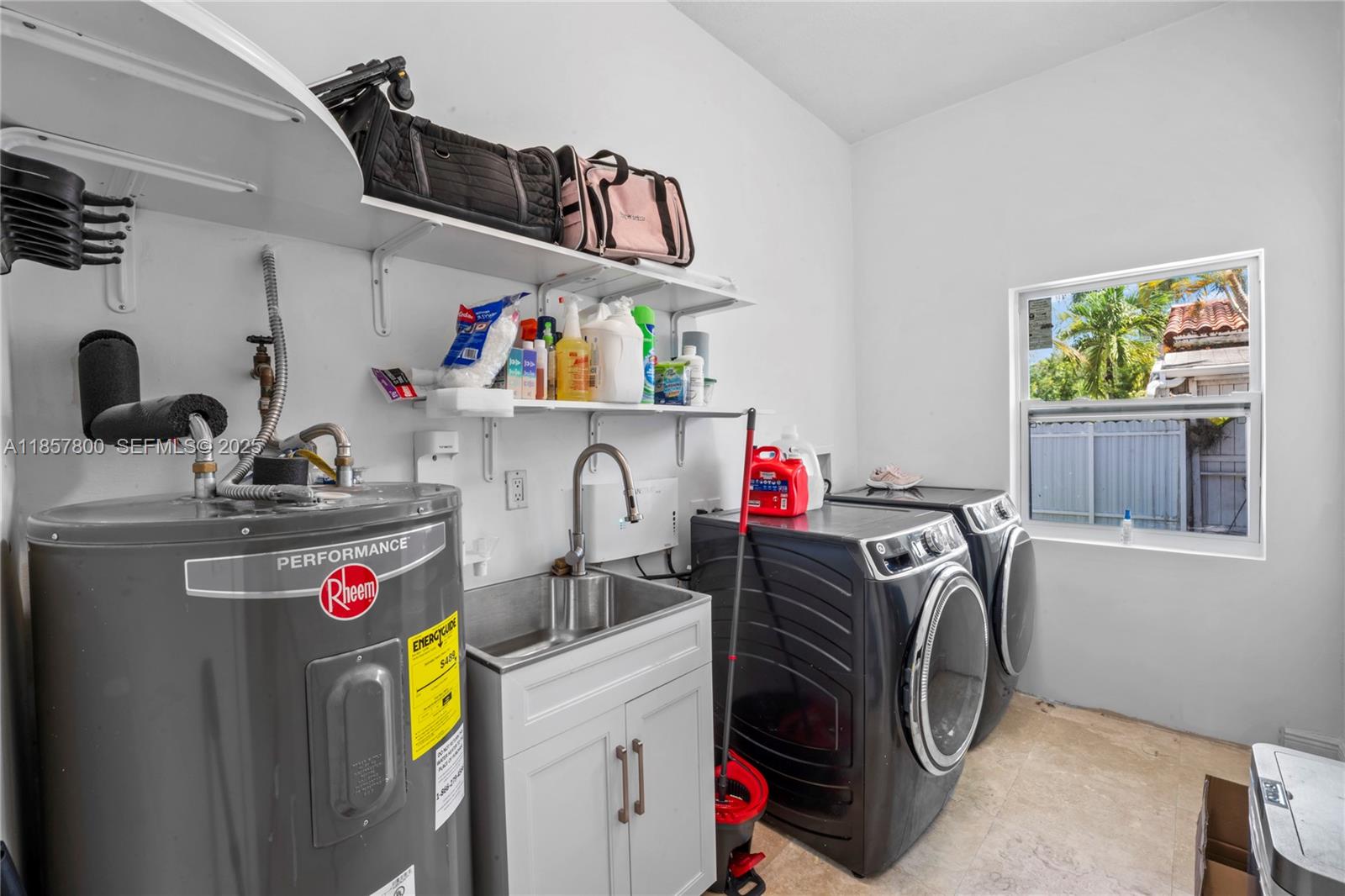 5750 Southwest 67th Avenue Miami, FL 33143 - Photo 33 of 62 a utility room with fridge dryer and washer