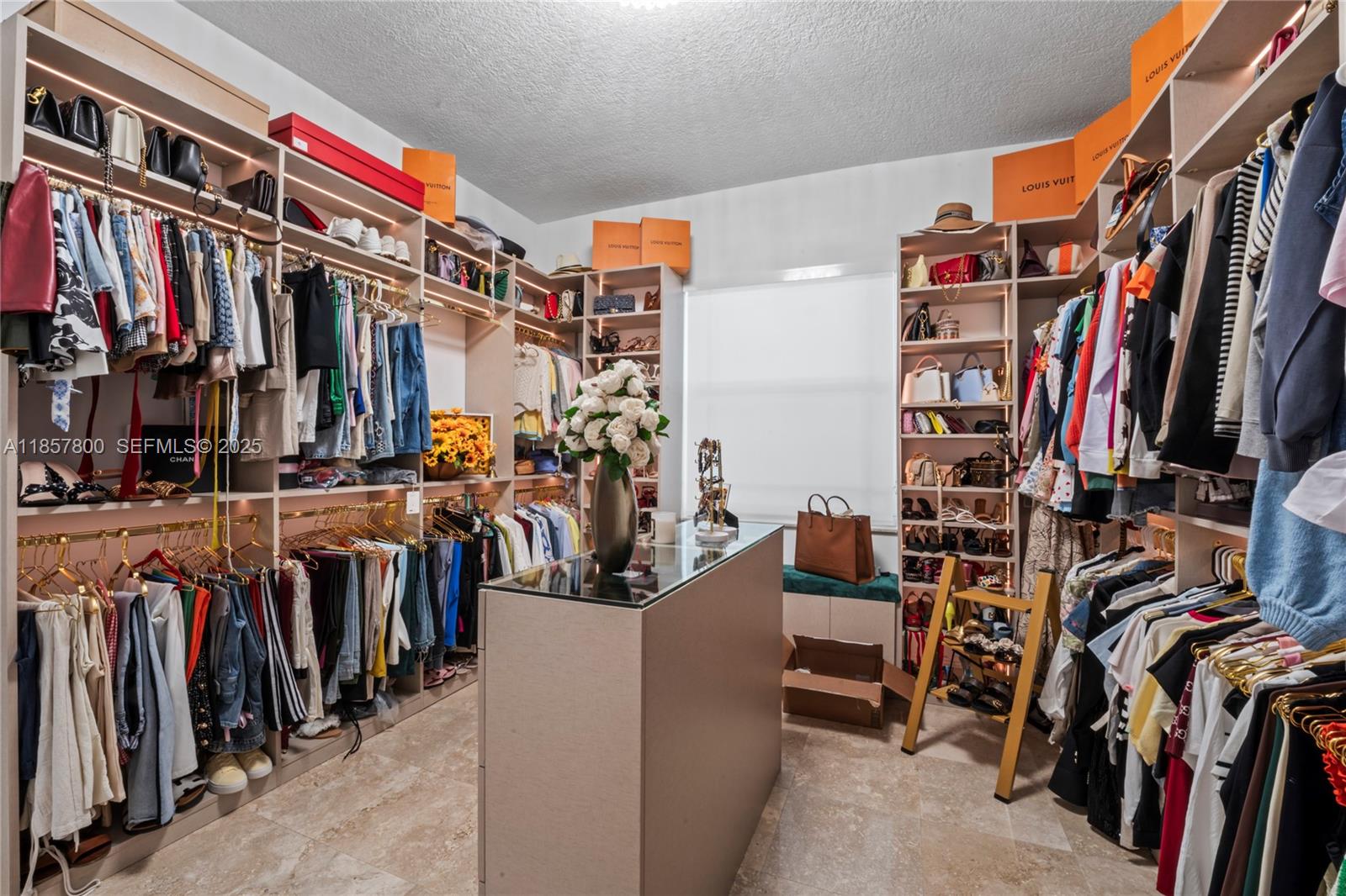 5750 Southwest 67th Avenue Miami, FL 33143 - Photo 35 of 62 a view of walk in closet with clothes and shoes