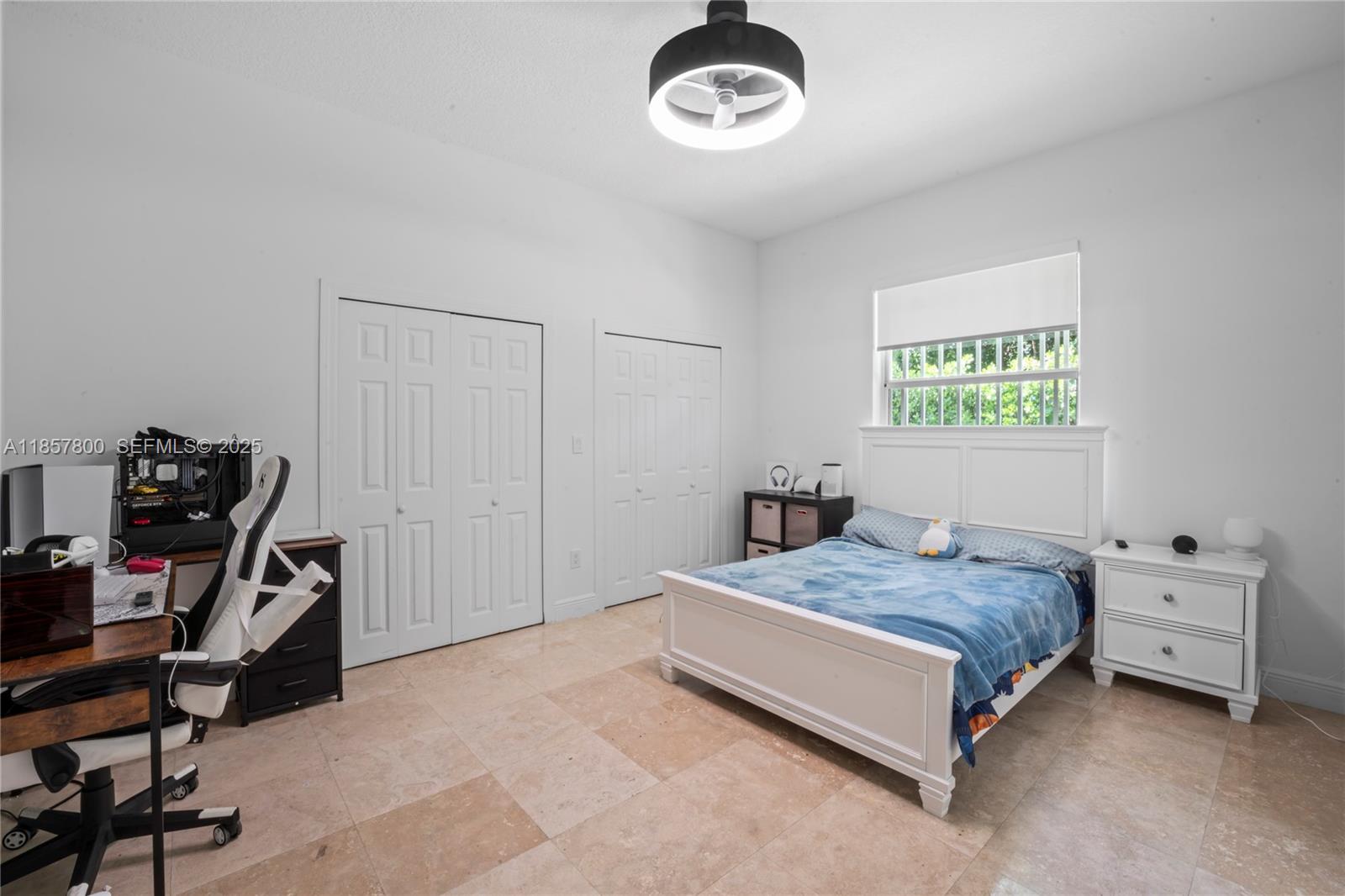 5750 Southwest 67th Avenue Miami, FL 33143 - Photo 40 of 62 a bedroom with a bed and a chandelier