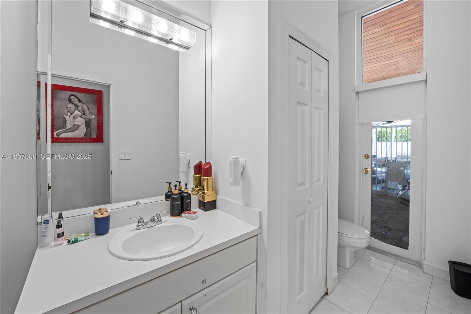 5750 Southwest 67th Avenue Miami, FL 33143 - Photo 42 of 62 a bathroom with a sink vanity granite and a mirror