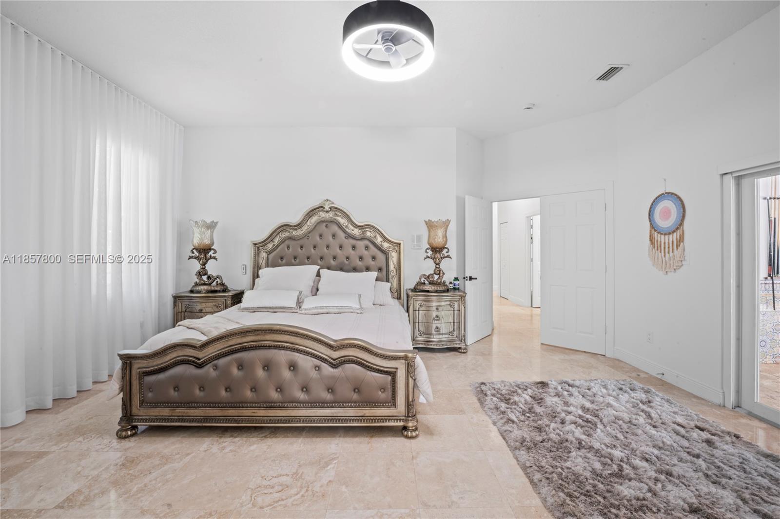 5750 Southwest 67th Avenue Miami, FL 33143 - Photo 47 of 62 a bedroom with a bed and a chandelier