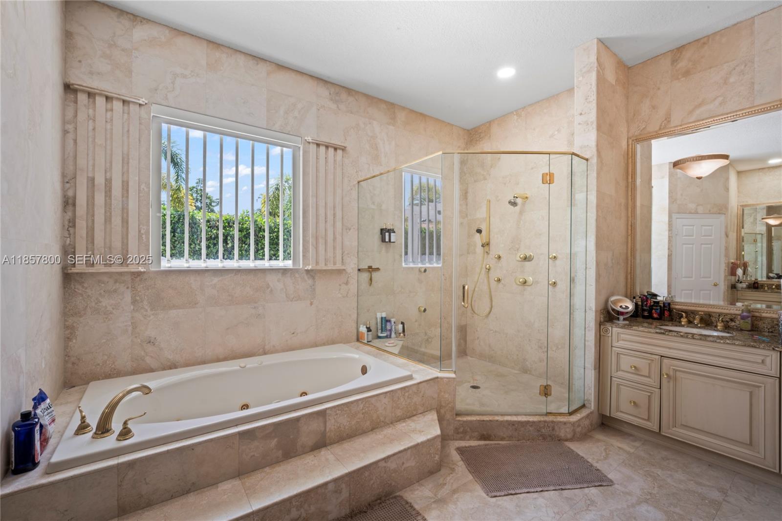 5750 Southwest 67th Avenue Miami, FL 33143 - Photo 49 of 62 a bathroom with a tub a sink and a shower