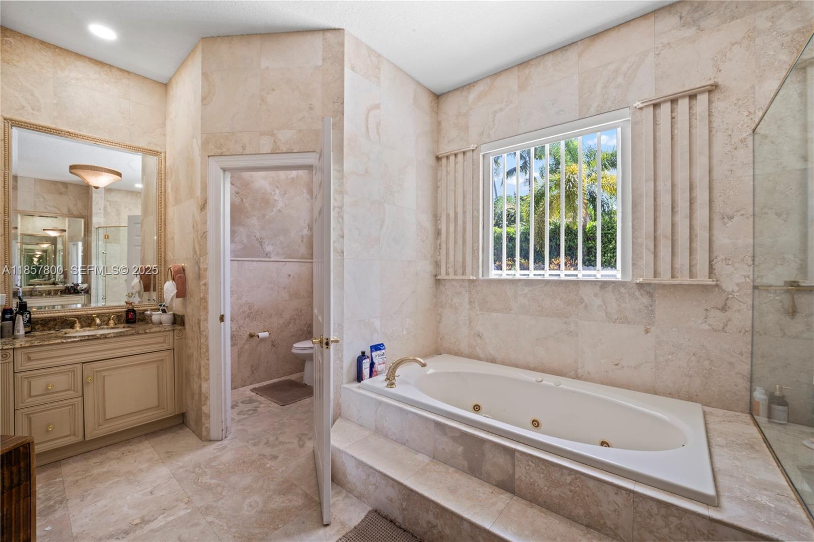5750 Southwest 67th Avenue Miami, FL 33143 - Photo 50 of 62 a bathroom with a tub a sink and a shower