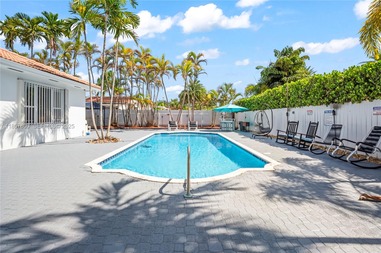 5750 Southwest 67th Avenue Miami, FL 33143 - Photo 61 of 62 a view of a backyard with swimming pool and furniture