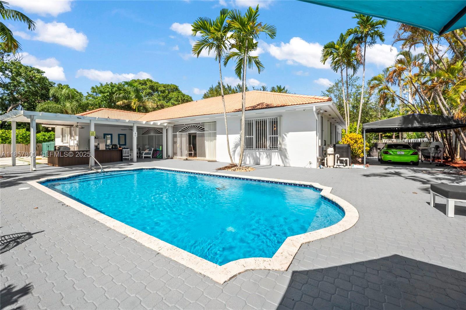 5750 Southwest 67th Avenue Miami, FL 33143 - Photo 10 of 62 a view of a patio with swimming pool table and chairs