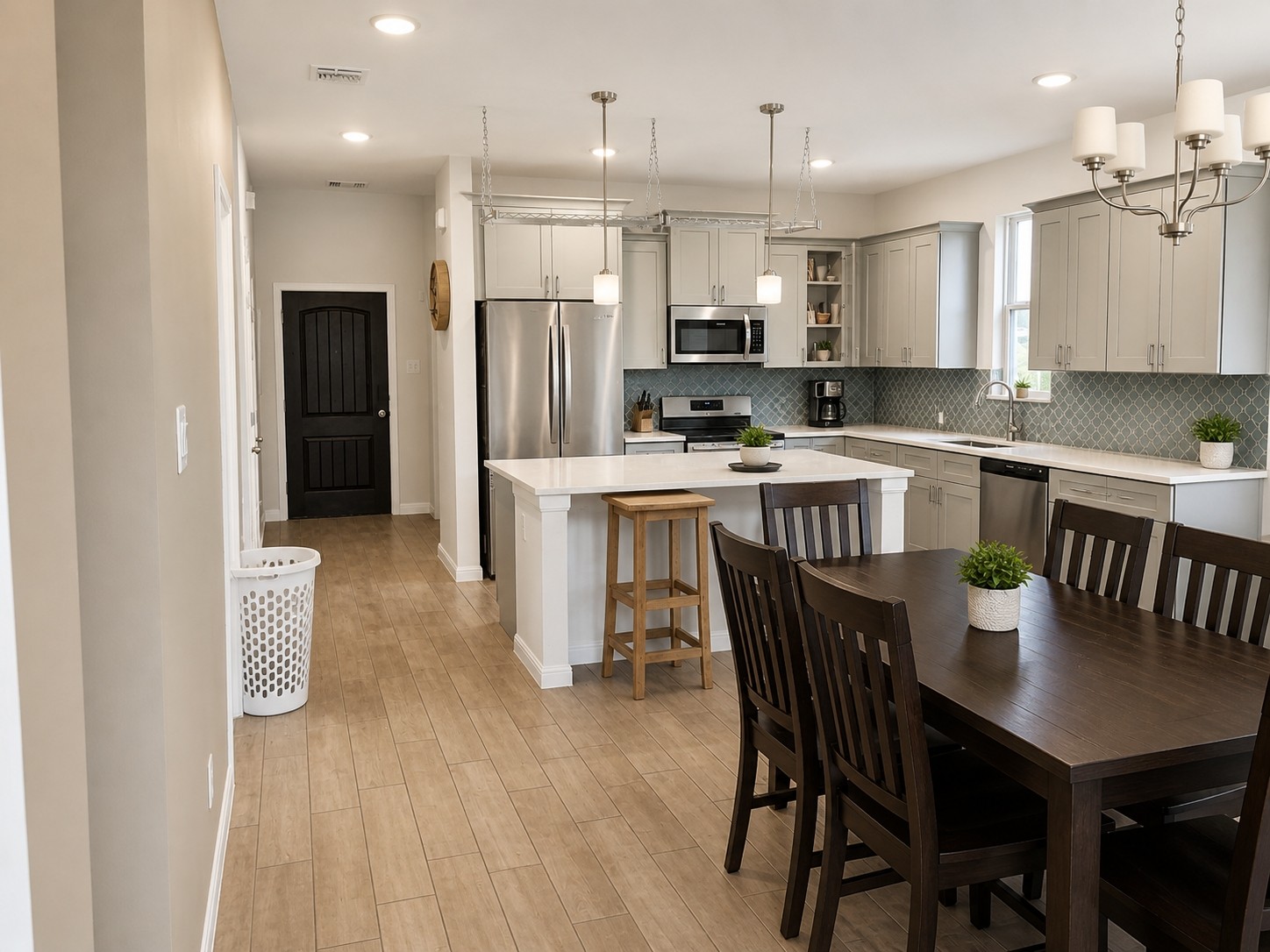 324 Windstar Road Liberty Hill, TX 78642 - Photo 2 of 6 Open-concept kitchen and dining area featuring wood-finish flooring, recessed lighting, and a chandelier