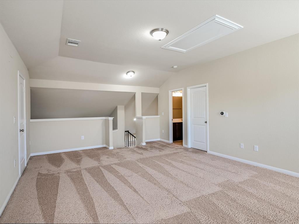 141 Serrano Street Georgetown, TX 78628 - Photo 6 of 7 A spacious carpeted loft area provides an additional versatile living space.