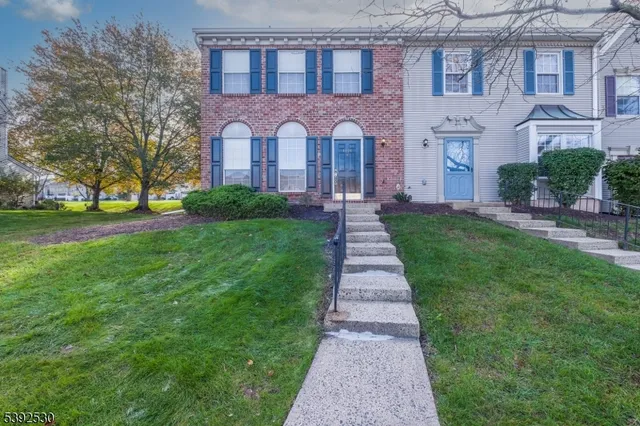 a front view of a brick house with a yard