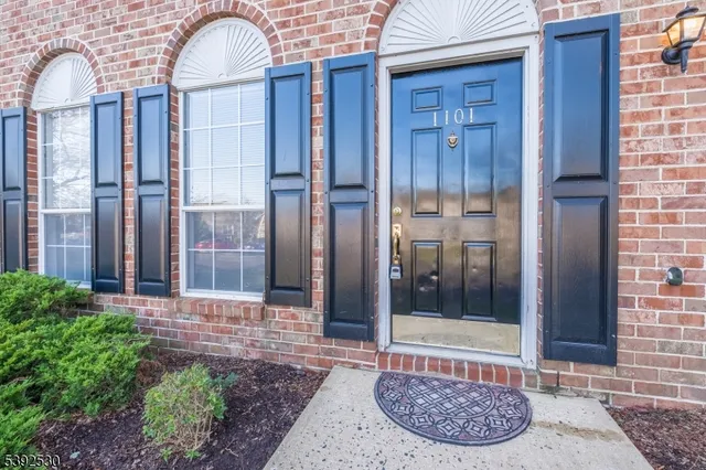 a view of a wooden door with a brick house