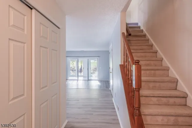 a view of an entryway with wooden floor