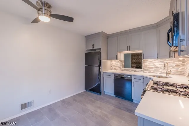 a kitchen with stainless steel appliances granite countertop a refrigerator stove and sink