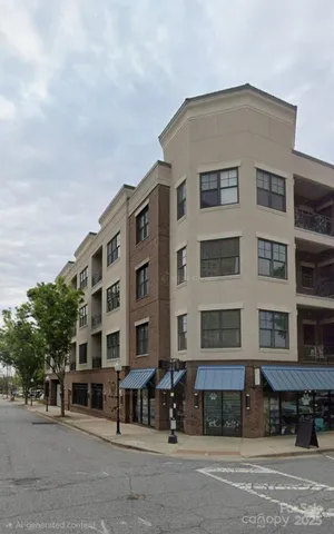 a front view of a building with lot of cars and trees